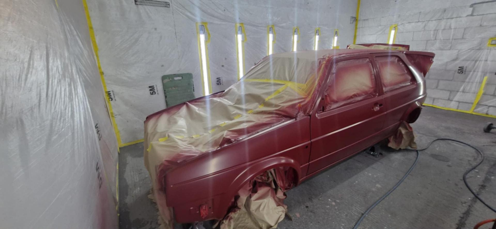 Red VW Golf masked and resprayed in the spray booth