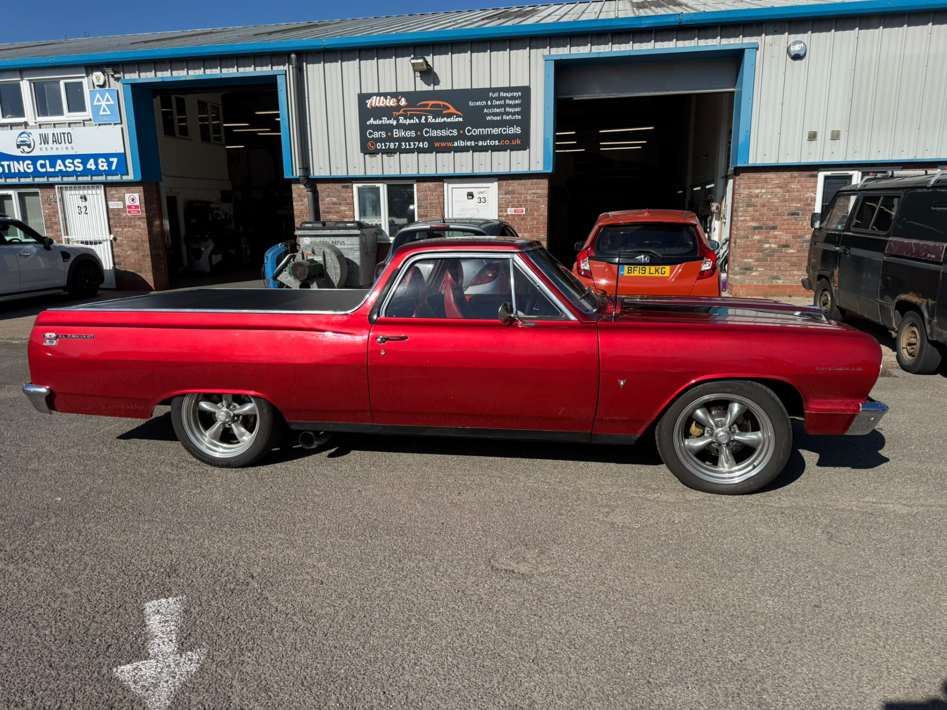 Red classic El Camino outside Albie's bodyshop